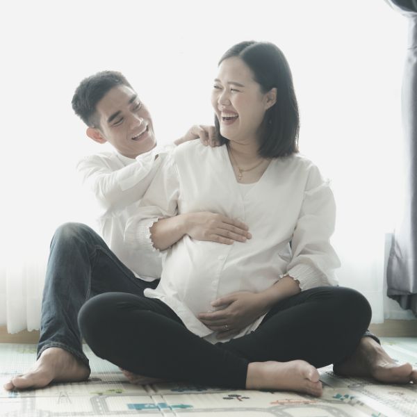 Husband and pregnant wife laughing