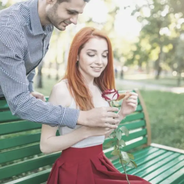 Man giving woman a flower