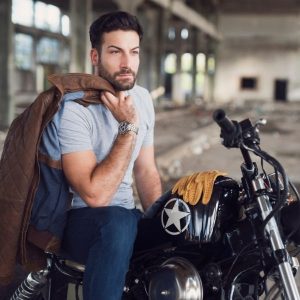 Man looking masculine on motor bike with leather jacket
