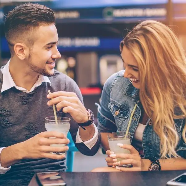 Shy guy on a date making a girl laugh