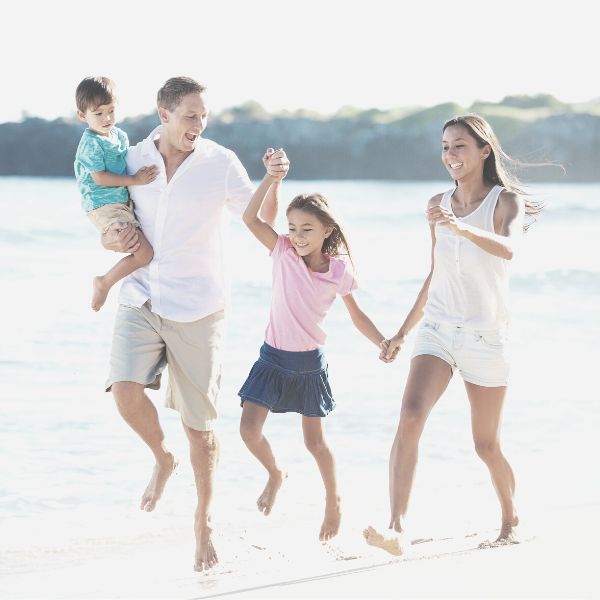 A husband and father on the beach with his family