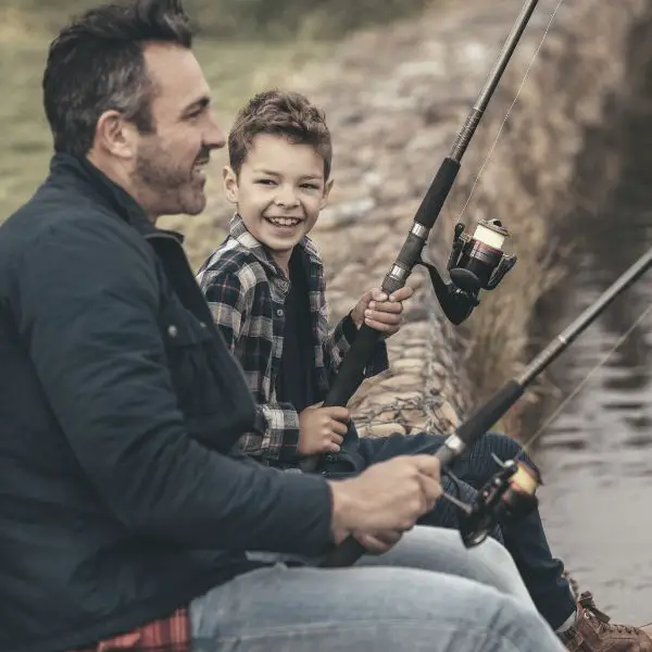 Man fishing with son using positive affirmations