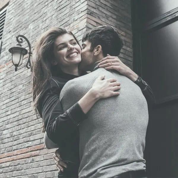 Guy and girl hugging and smiling