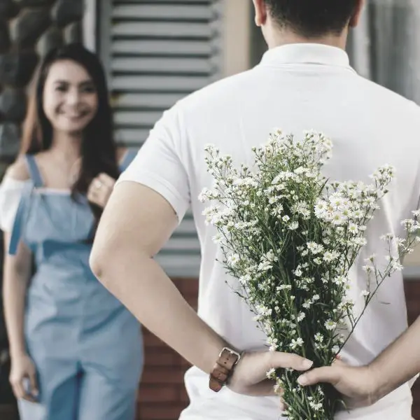 Guy giving his girlfriend flowers