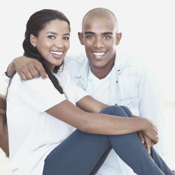 Guy hugging his wife smiling