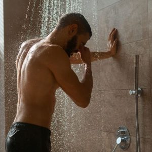 Guy in shower sad after letting go of someone he cares for