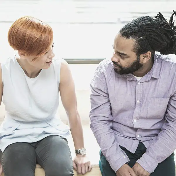 Guy sitting with a woman asking for her number