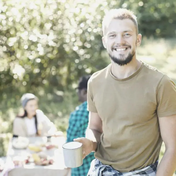 Man enjoying life with friends camping