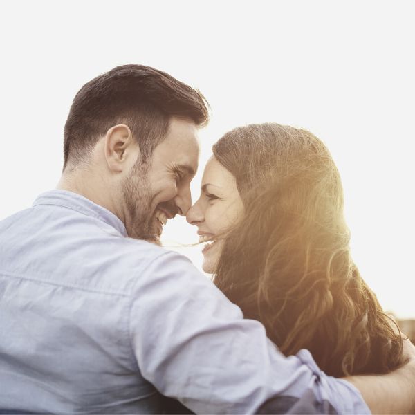 Couple in a relationship sitting and smiling at each other