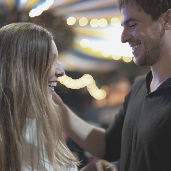 Guy at carnival making a woman laugh