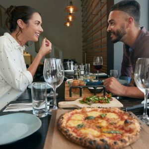 Woman giving mixed signals while on a date eating pizza