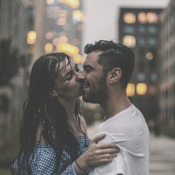 Woman kissing a guy on the cheek