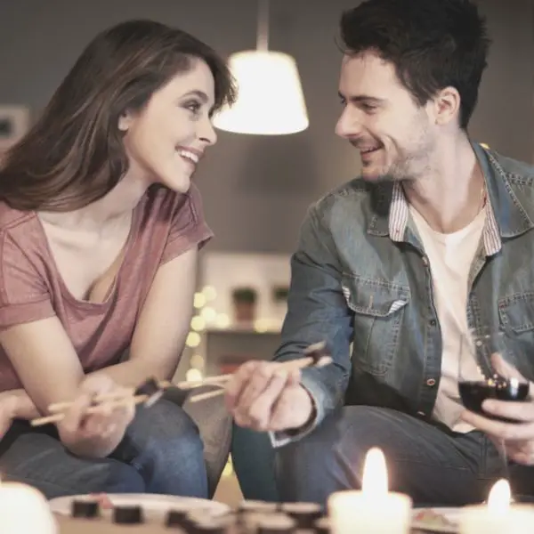 Woman looking a guy in the eyes and smiling while on a date