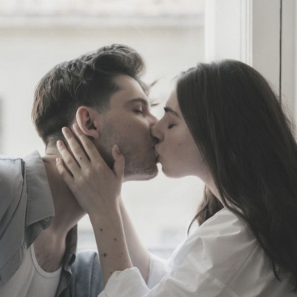 Woman pulling guy in for a kiss