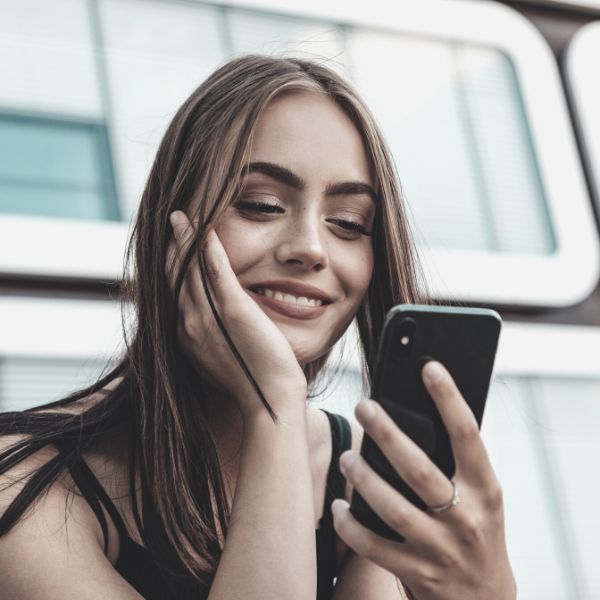 Woman smiling at a guy talking over FaceTime