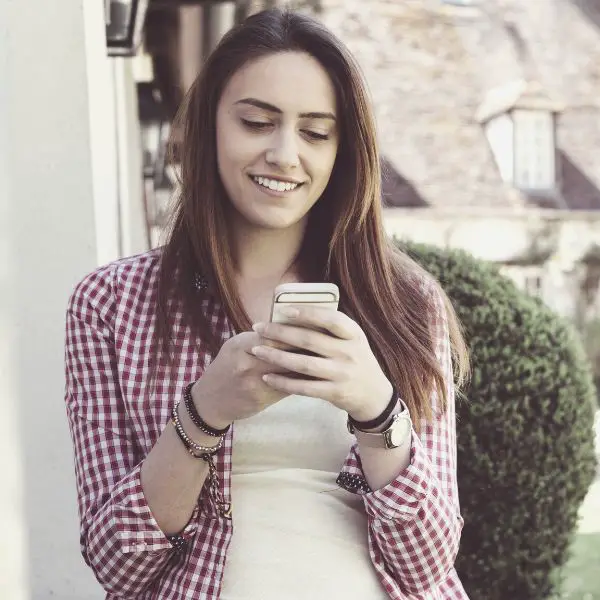 Young woman reading a text she got from a guy she just met