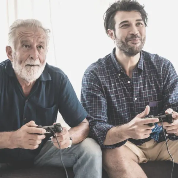 Younger guy and older guy playing video games