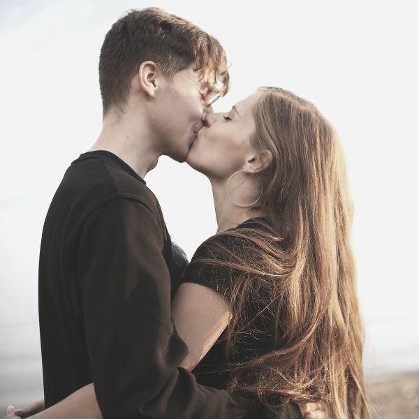 couple kissing in the sand