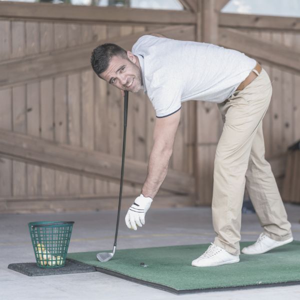 man playing golf at the driving range