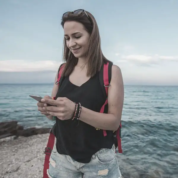 woman hiking reading a text from a gy she just met