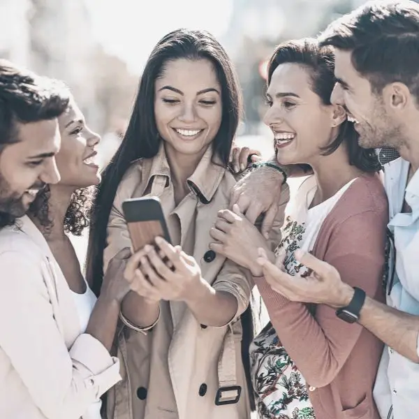 A group of men and woman laughing and having a good time