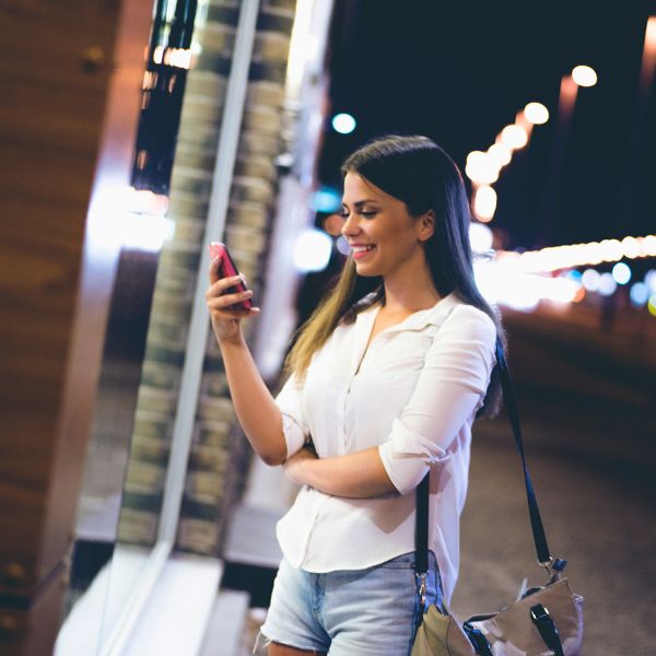 Girl smiling at a text she got from her crush